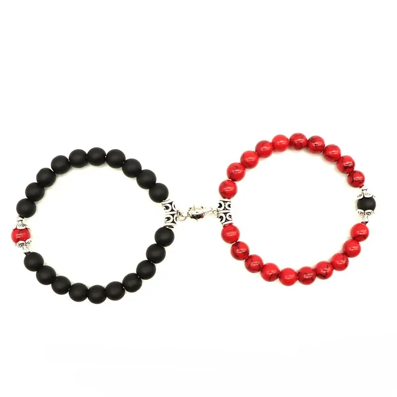 Intriguing beaded bracelet set with bold black and red stones, unique silver accents, and artistic style