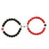 Intriguing beaded bracelet set with bold black and red stones, unique silver accents, and artistic style