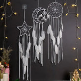 Intriguing star, moon, and circle dreamcatchers with white feathers, glowing fairy lights