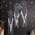 Intriguing star, moon, and circle dreamcatchers with white feathers, glowing fairy lights