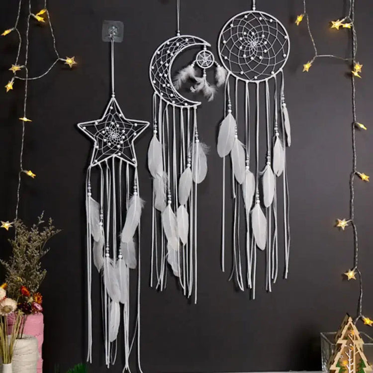 Intriguing star, moon, and circle dreamcatchers with white feathers, glowing fairy lights