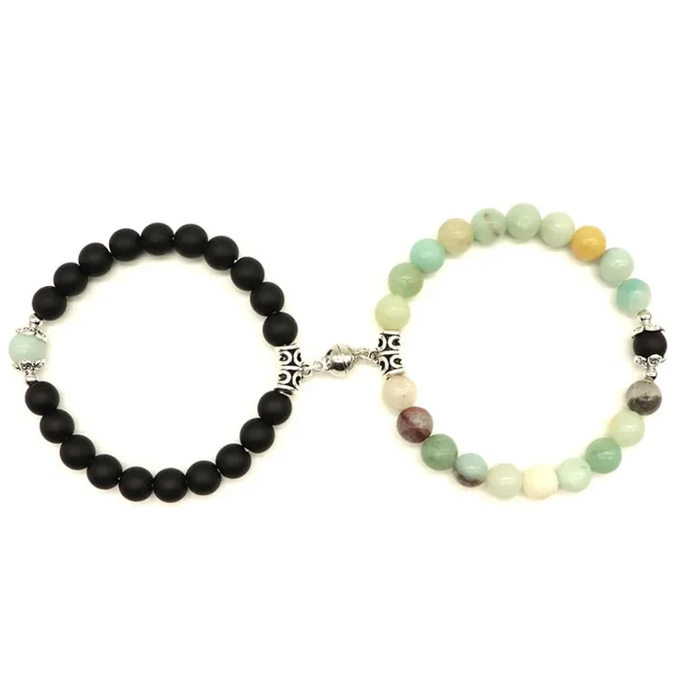 Curious dual-bead stretch bracelets with black and pastel stones, silver accents, linked uniquely.