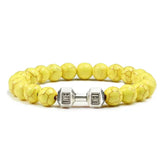 Bright yellow beaded bracelet with unique silver dumbbell charm, perfect for bold jewelry lovers