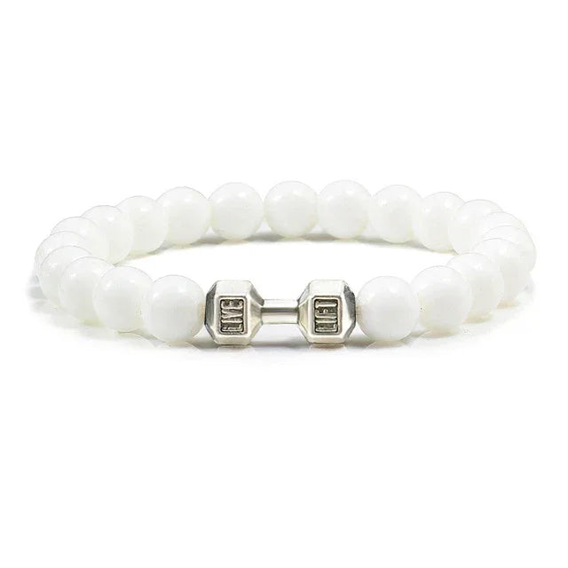 Elegant white beaded bracelet with unique silver dumbbell charm for stylish, standout jewelry