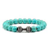 Eye-catching turquoise bead bracelet with unique dumbbell charm, perfect for bold style lovers.