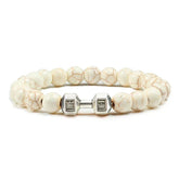 Intriguing white beaded bracelet with silver dumbbell charm, perfect for unique jewelry lovers.