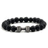 Distinctive black lava bead bracelet with a unique silver dumbbell charm, bold and stylish