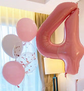 Playful pink number 4 balloon and confetti-filled balloons for unique party decor