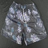 Bold black mesh shorts with unique purple floral print and white drawstring, stylish summer wear