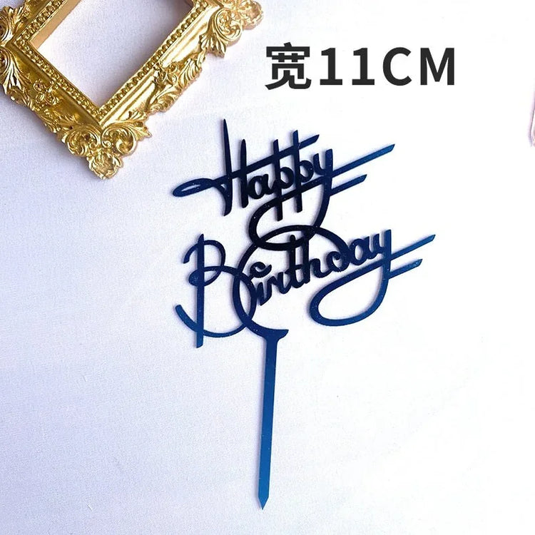 Unique blue acrylic Happy Birthday cake topper with elegant script beside ornate gold frame.