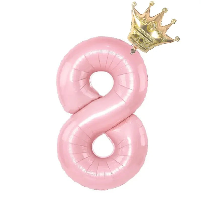 Playful pink number eight balloon with a shiny gold crown, a unique party décor accent.