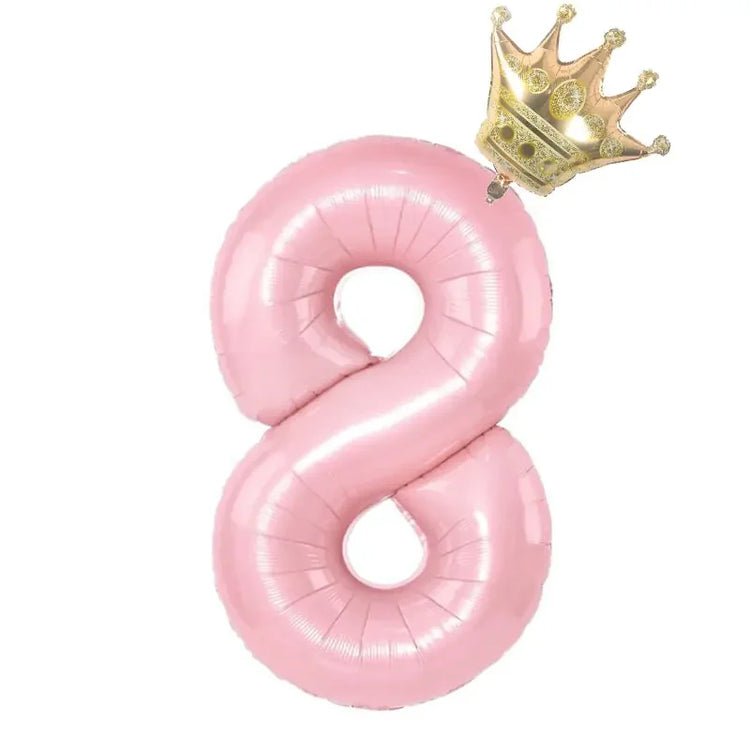 Playful pink number eight balloon with a shiny gold crown, a unique party décor accent.