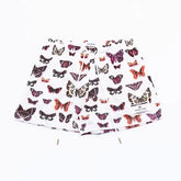 Curiously unique white shorts with vibrant butterfly print, perfect for standout style