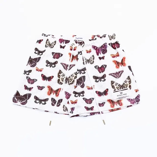 Curiously unique white shorts with vibrant butterfly print, perfect for standout style
