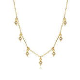 Elegant gold necklace with diamond-shaped charms and sparkling stones, uniquely stylish look