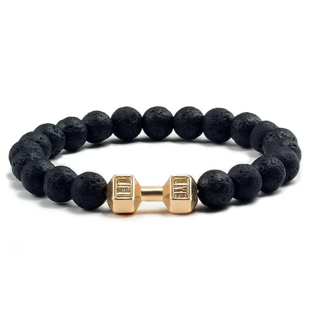 Bold black lava bead bracelet with a unique gold dumbbell charm, perfect for standout style.