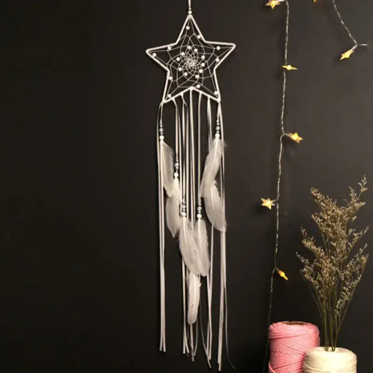 Enchant your space with a star-shaped dreamcatcher, white feathers, and cozy string lights.