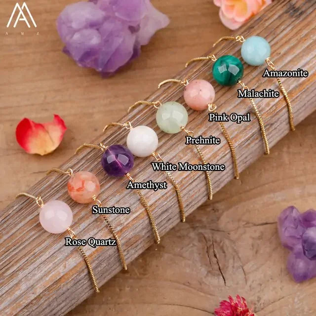 Colorful gemstone bead bracelets including amethyst, rose quartz, malachite, and more on wood.