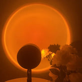 Modern sunset projection lamp casting a glowing orange circle, unique floral home décor