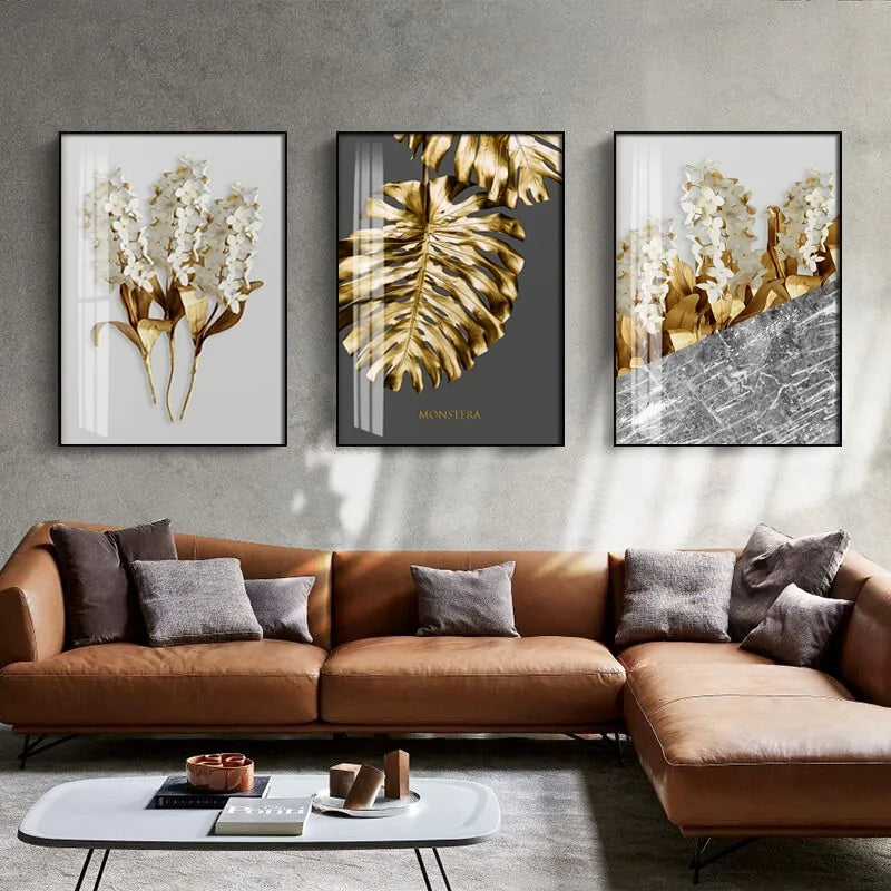 Modern living room with brown leather sofa, abstract gold botanical wall art, and unique décor accents.