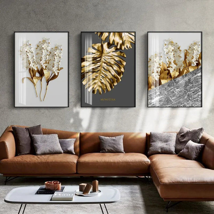Modern living room with brown leather sofa, abstract gold botanical wall art, and unique décor accents.