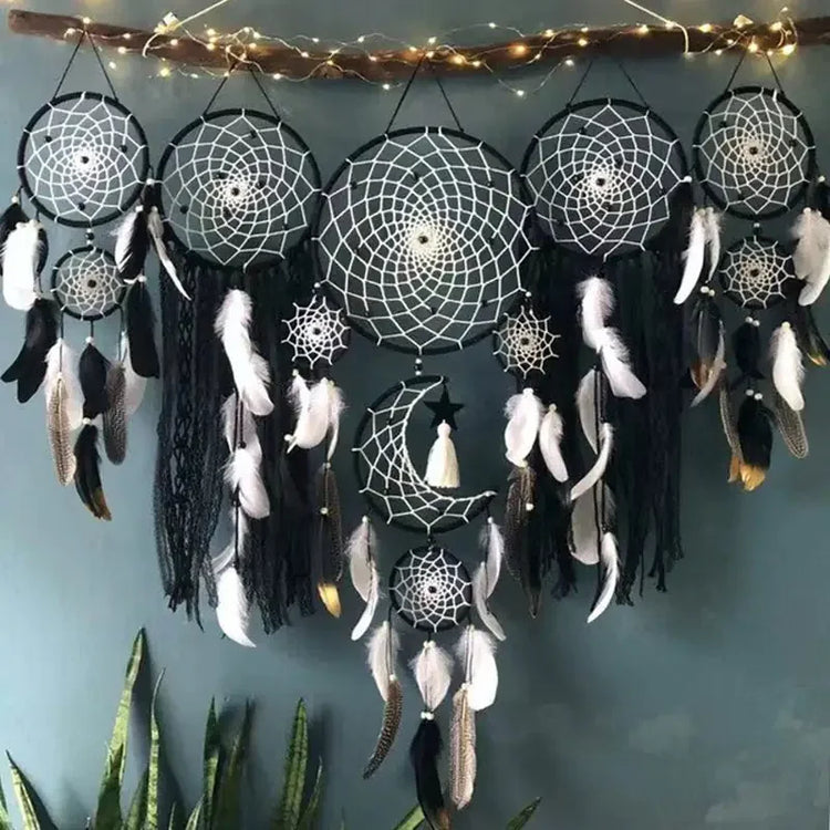 Enchanting black and white dreamcatcher wall decor with feathers, moon motif, and string lights