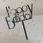 Sleek black Happy Birthday cake topper with gold star confetti, adding unique celebration flair.