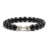 Sleek black beaded bracelet with unique silver dumbbell charm, perfect for bold style