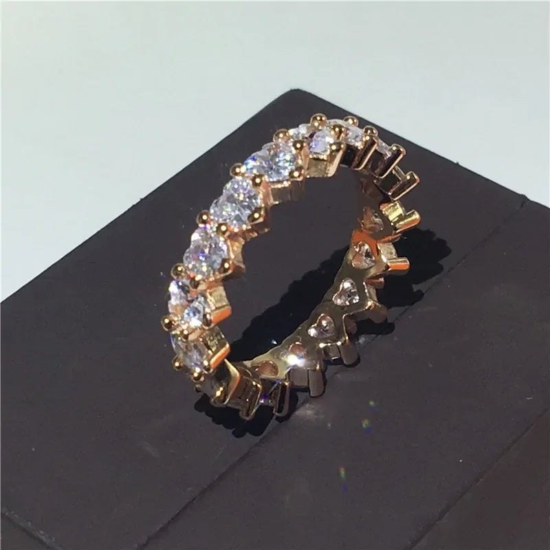 Sparkling gold eternity ring with round cut stones, a striking statement piece for any style.