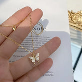 Sparkling gold butterfly pendant necklace shines in natural light, perfect for unique style.