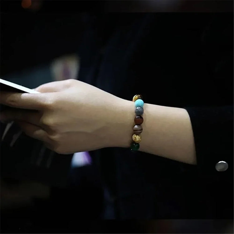 Hand wearing a vibrant beaded gemstone bracelet, showcasing unique style and elegant jewelry.