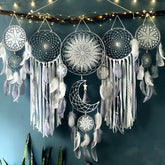 Intriguing wall décor with intricate dreamcatchers, feathers, and twinkling fairy lights