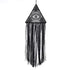 Intriguing black triangle macrame wall hanging with eye motif and flowing textured fringe, perfect for unique home décor.
