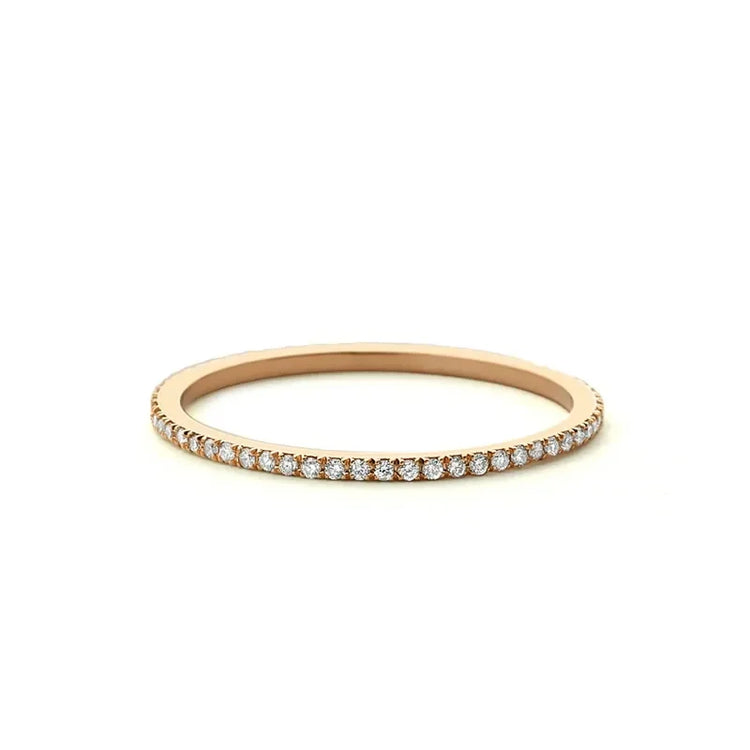 Dazzling rose gold diamond eternity band, perfect for curious lovers of unique jewelry style.