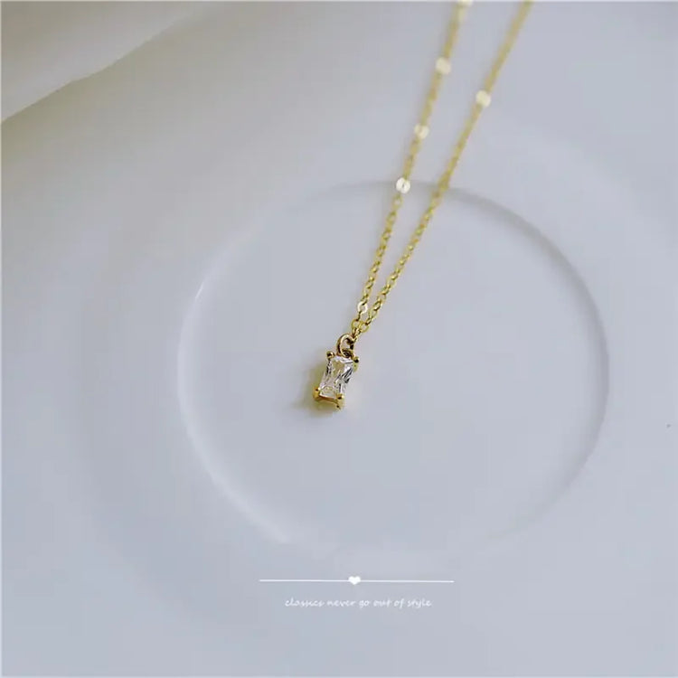 Elegant gold chain necklace with a sparkling rectangular pendant, perfect for unique style seekers