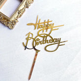 Elegant gold Happy Birthday cake topper, stylish and unique party decoration on white surface