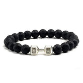 Intriguing black lava stone bead bracelet with a unique silver dumbbell charm, perfect for stylish self-expression.