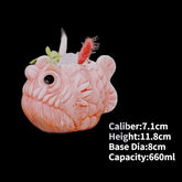 Quirky pink fish-shaped mug with detailed texture, feathers, and playful large eye, 660ml capacity