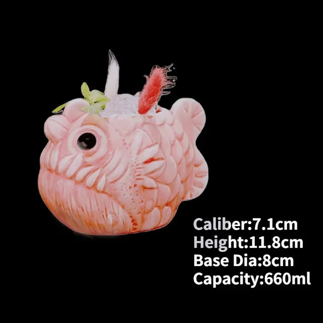 Quirky pink fish-shaped mug with detailed texture, feathers, and playful large eye, 660ml capacity